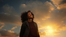 Middle aged Black woman looking up at the sky. 