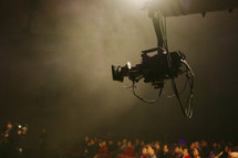 a video camera over an audience 