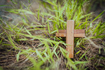 small wooden cross in grass