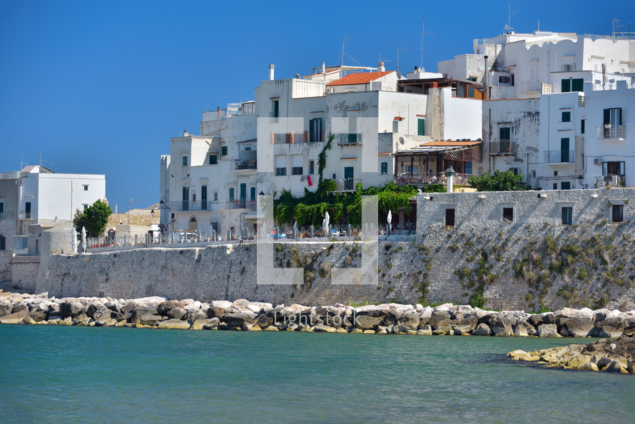 houses from the coast of Vieste on a sunny day, Puglia region, Italy