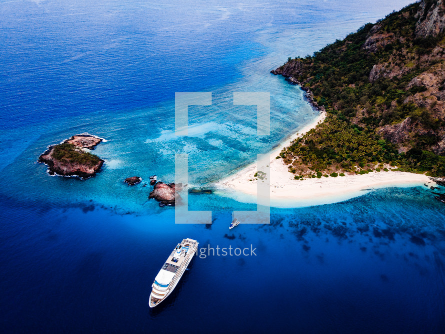 aerial view over a cruise ship and blue sea