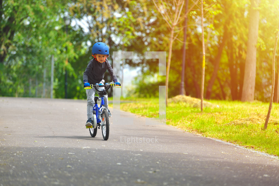 child riding a bike with a helmet 