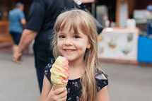 smiling girl holding an ice cream cone 