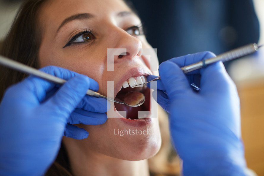 a woman at the dentist getting a dental exam 