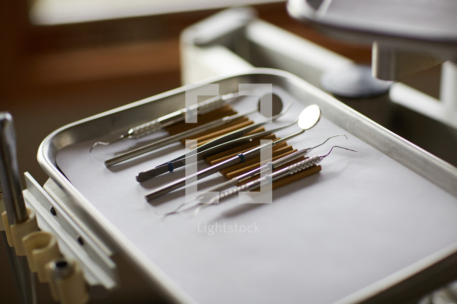dental tools on a silver tray