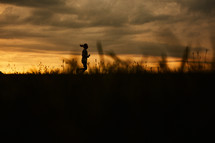 silhouette of a woman running at sunset 