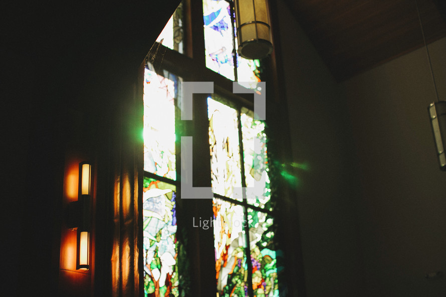 light of God shining through a church's stain glass window