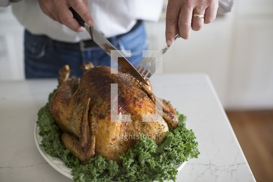 a man carving a Thanksgiving turkey 