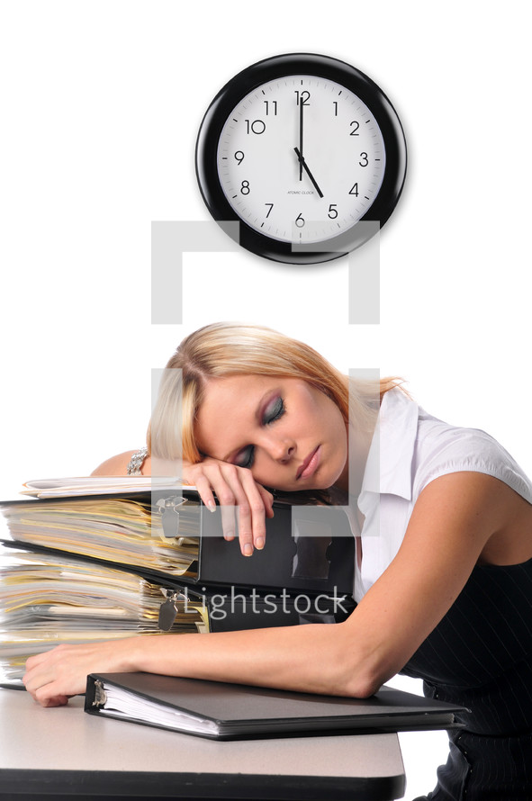 overworked woman sleeping on a stack of books 
