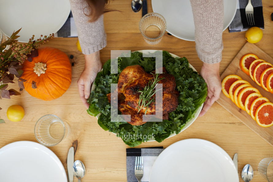 putting the turkey on the table at Thanksgiving 