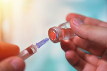 vaccine bottle with syringe and needle for immunization 