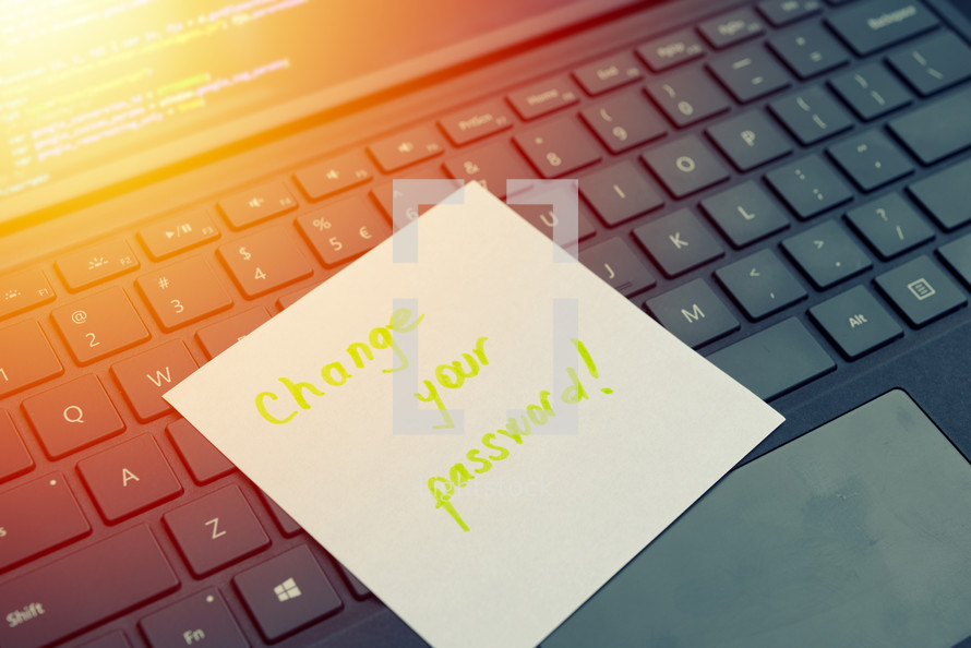 Change your password message concept written post it on laptop keyboard