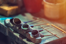 A pottery decorator ceramic painting tools full of paint