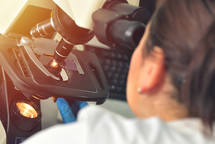 scientist using microscope in medical laboratory