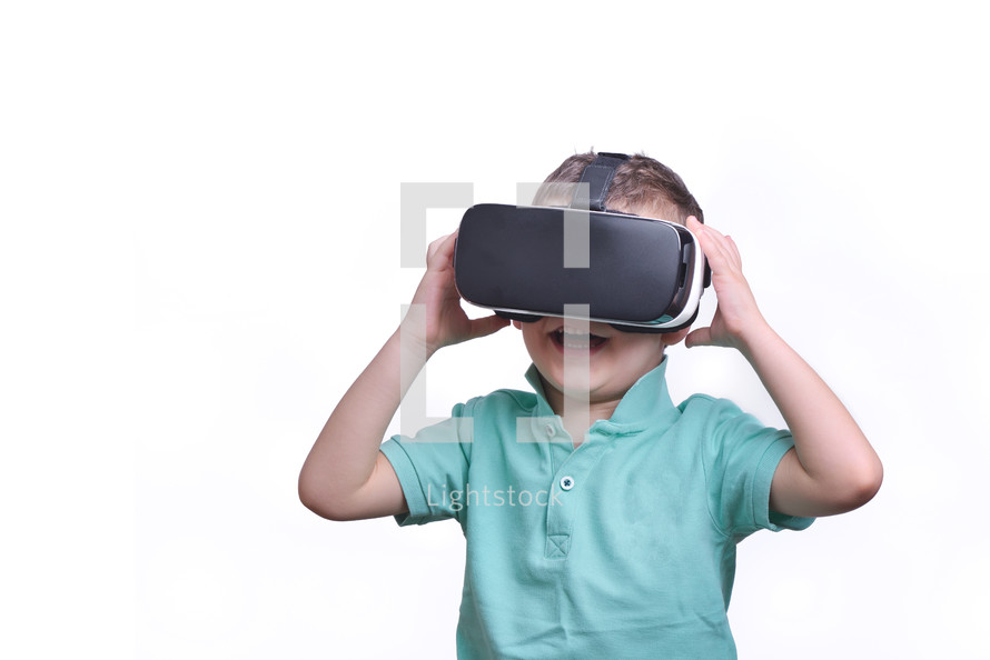 boy wearing virtual reality goggles watching movies or playing video games, isolated on white