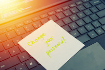 Change your password message concept written post it on laptop keyboard