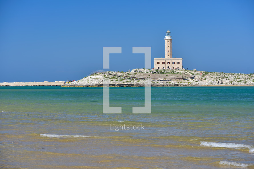 Lighthouse from the coast of Vieste on a sunny day, Puglia region, Italy