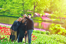 A couple of middle age family taking a selfie photo in Keukenhof Gardens