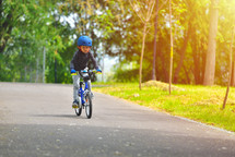 child riding a bike with a helmet 