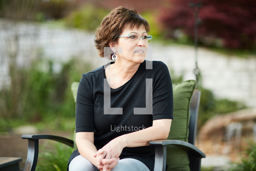 a woman sitting outdoors relaxing 