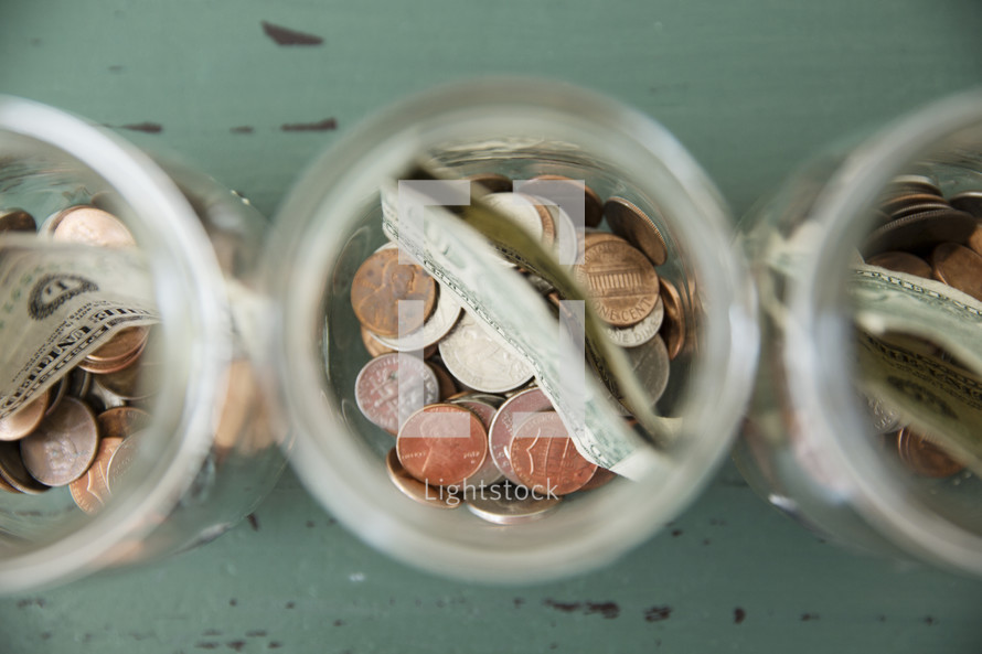 money divided in jars 