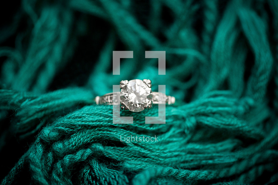 engagement ring on a turquoise scarf