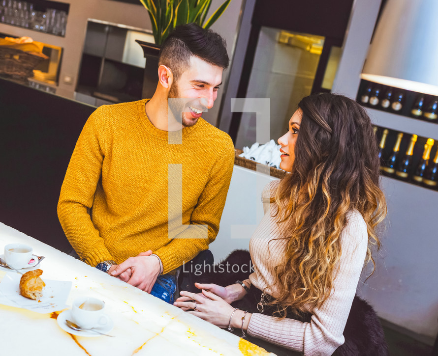 Couple talking at a coffee shop