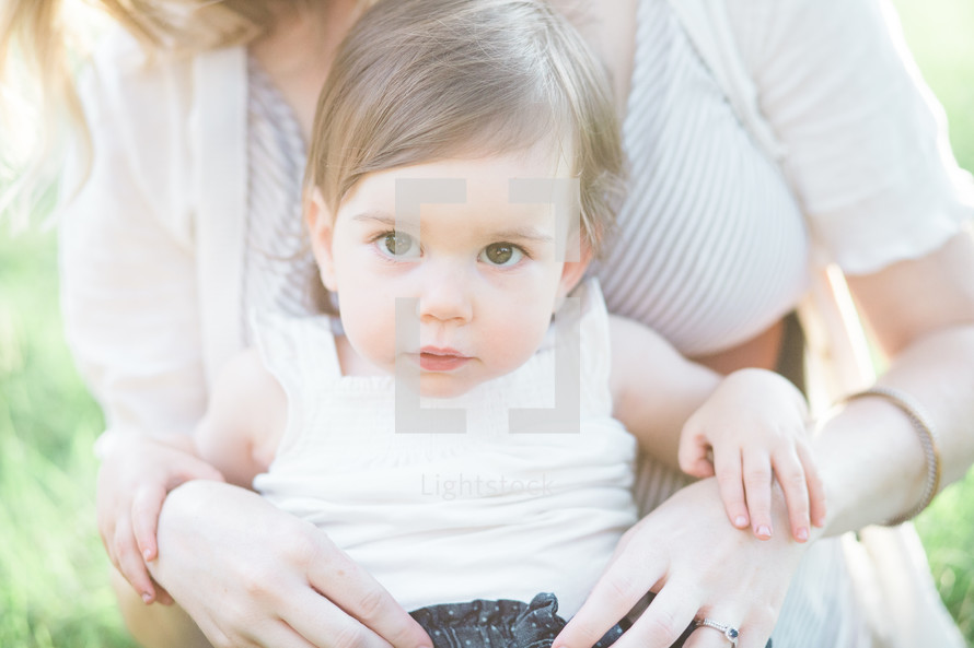 toddler girl in mother's lap 