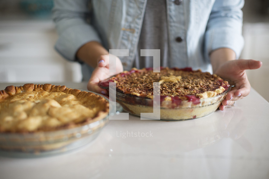 a woman baking pies in the kitchen 