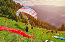 Paraglider taking off in front of spectacular mountain scenery