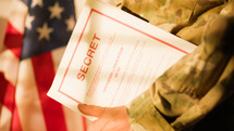American soldier enters office with folder