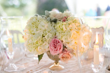 flowers in a vase as a centerpiece on a table at a wedding reception 