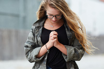 girl with head bowed in prayer 