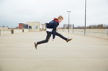 teen boy jumping up 
