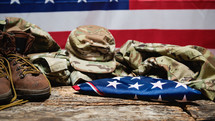 Memorial Day Background with Soldier's Uniform and Folded Flag