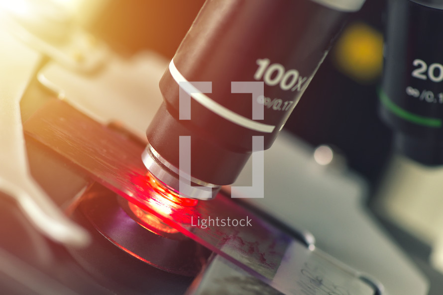 Microscope in medical laboratory analyzing a test sample