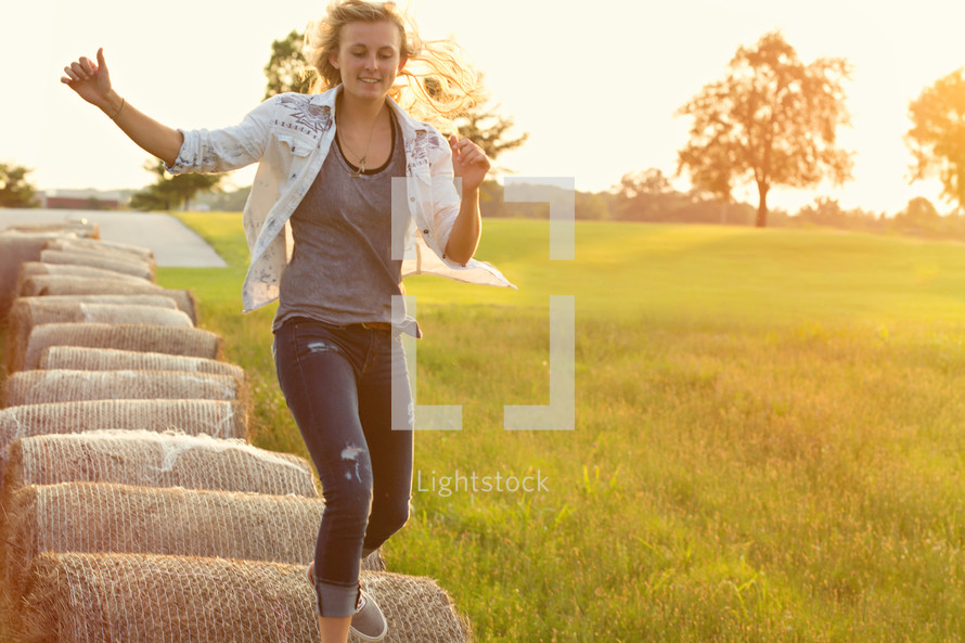 woman running on hay bales 
