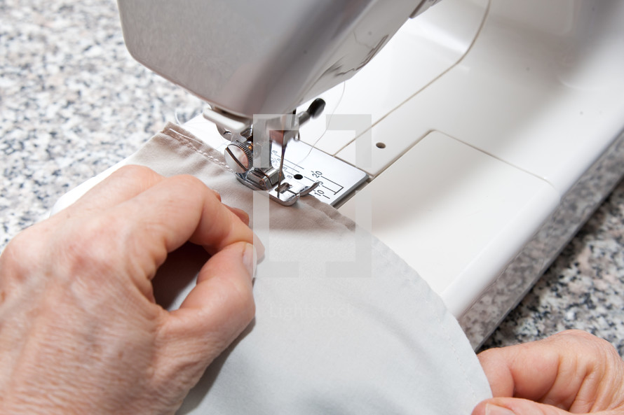 seamstress working on sewing machine.