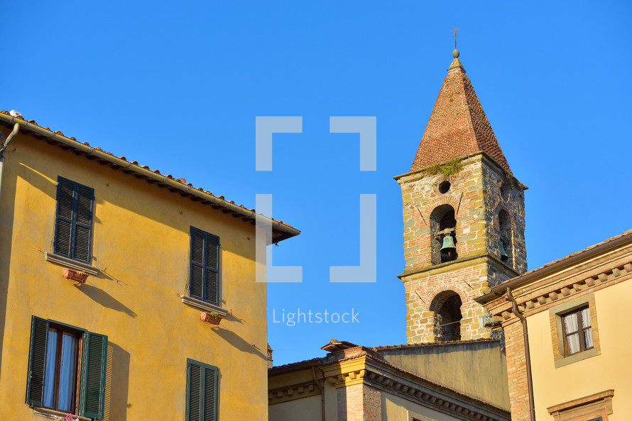 Close-up of colorful buildings, bell tower and rooftops in a blue sunny day at Umbertide, a gracious little town near Perugia, Italy