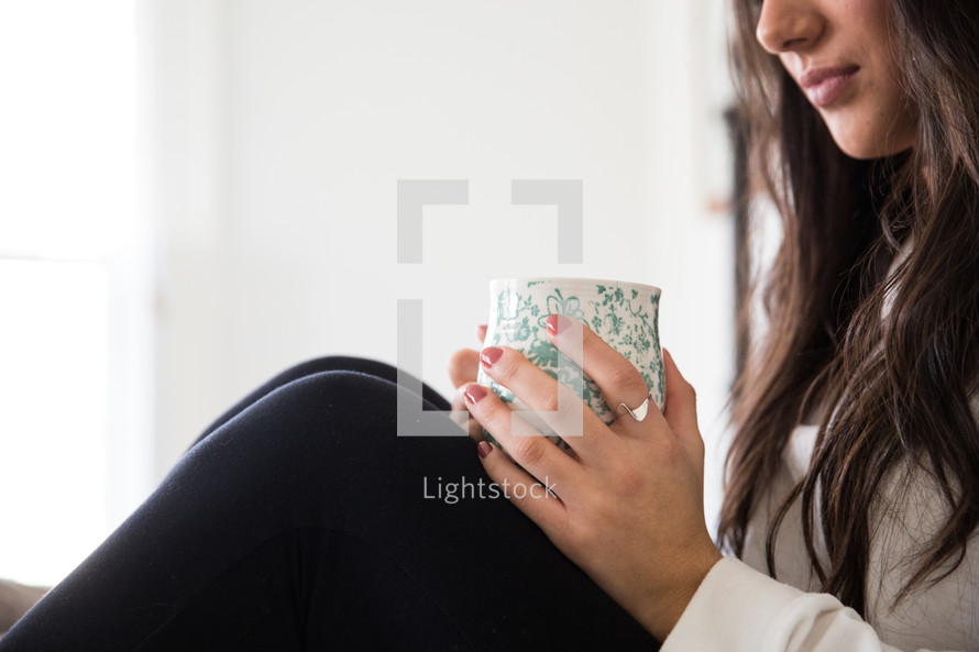 woman sitting with a mug in her lap 