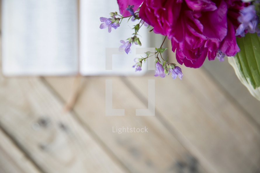 flowers in a vase on a wood table 