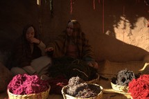 women with baskets of dyed yarn 