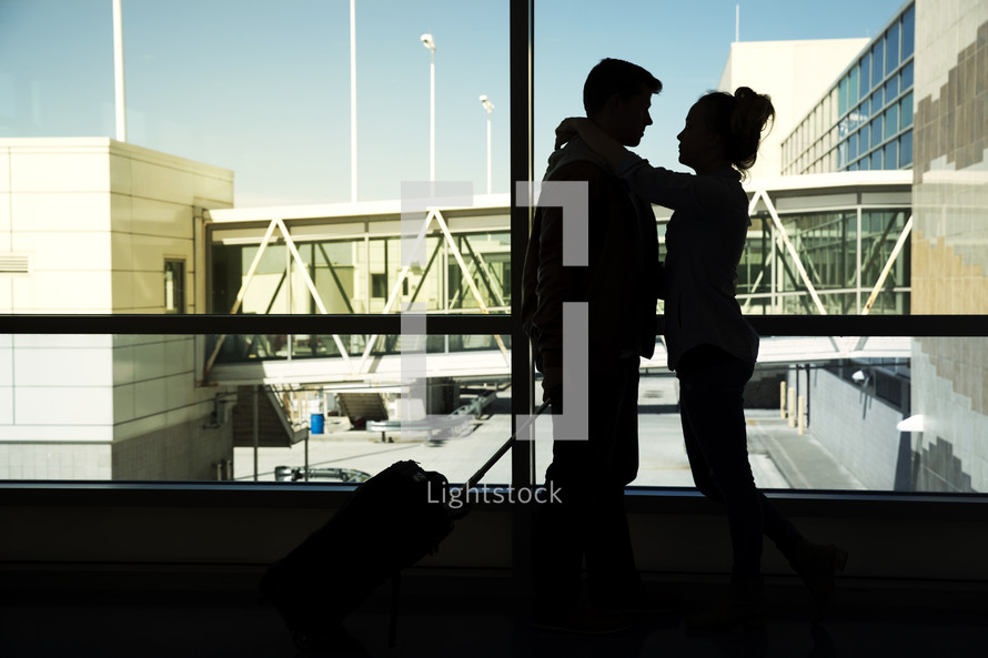 a couple with luggage at the airport 