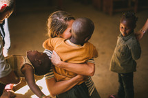 missionary hugging a child 