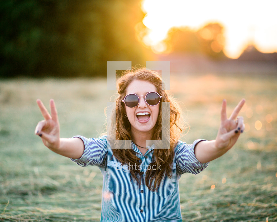 teen girl showing peace signs 