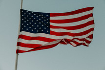 American flag on a flag pole in the sky 
