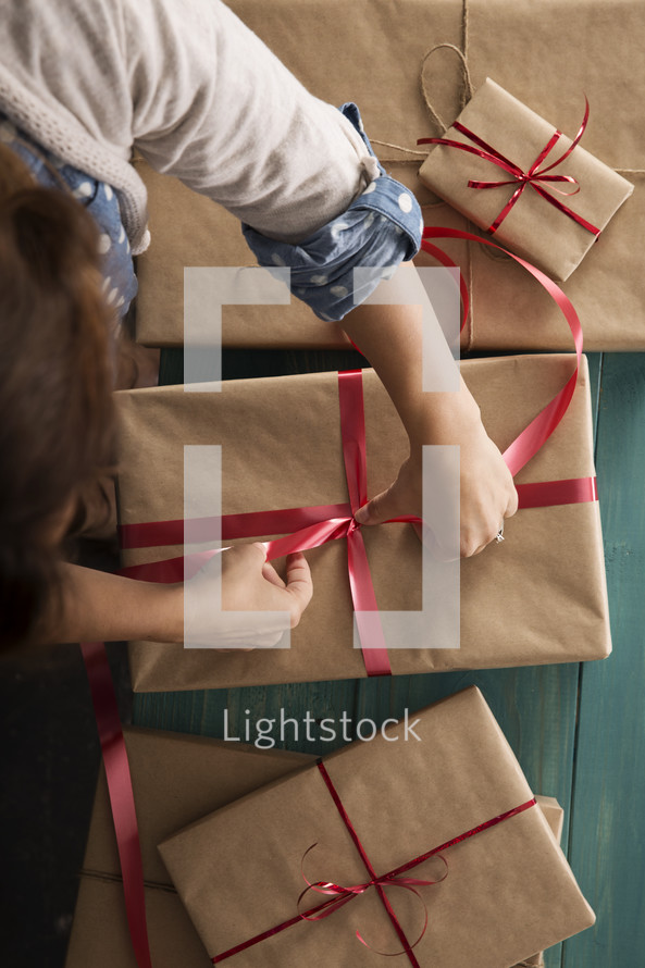 a woman wrapping Christmas gifts 