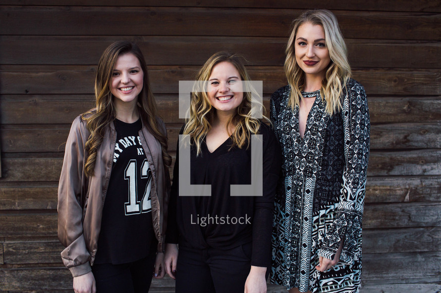 portrait of young women standing together outdoors 