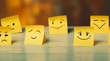 Mixed emotions drawn on yellow sticky notes. 