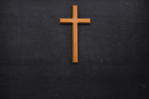 wooden cross on a black background 